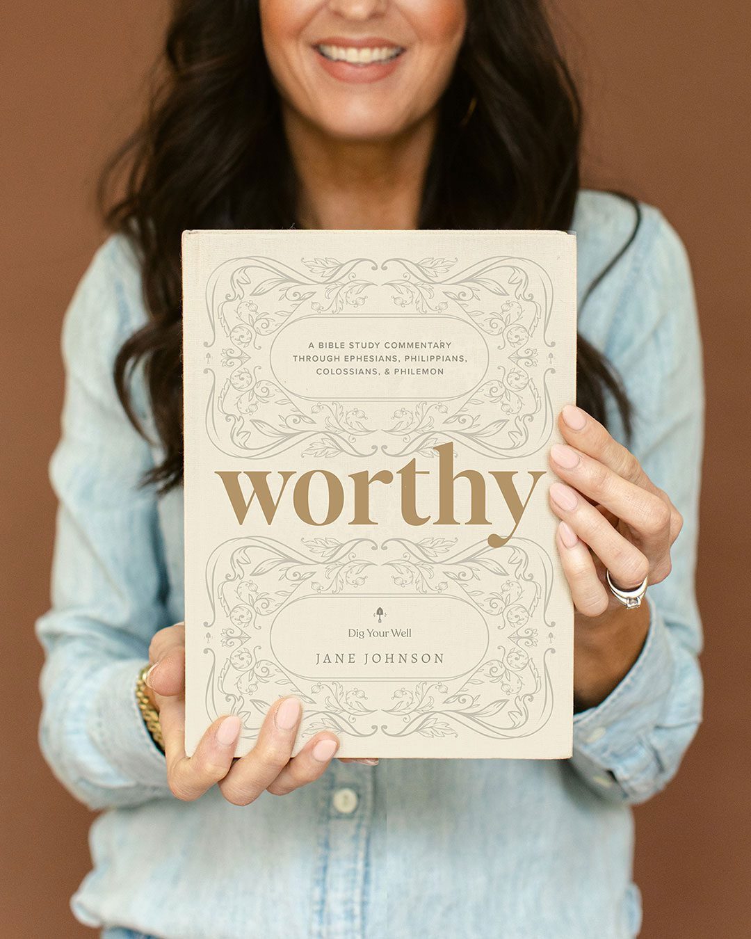 Jane Johnson holding her book Worthy